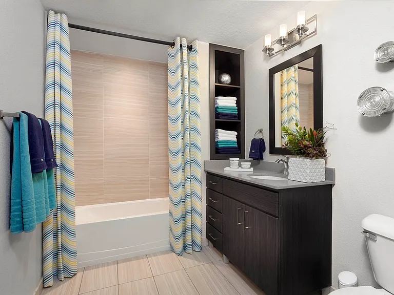 Spacious bathrooms with built-in shelves and framed mirrors