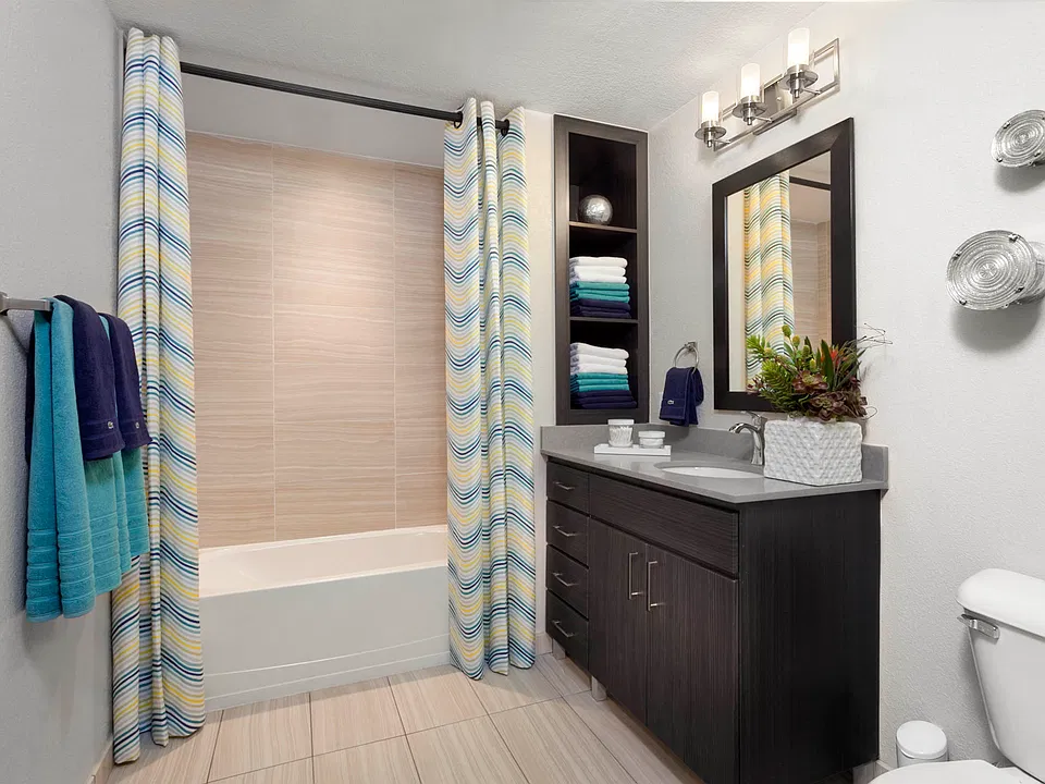 Spacious bathrooms with built-in shelves and framed mirrors