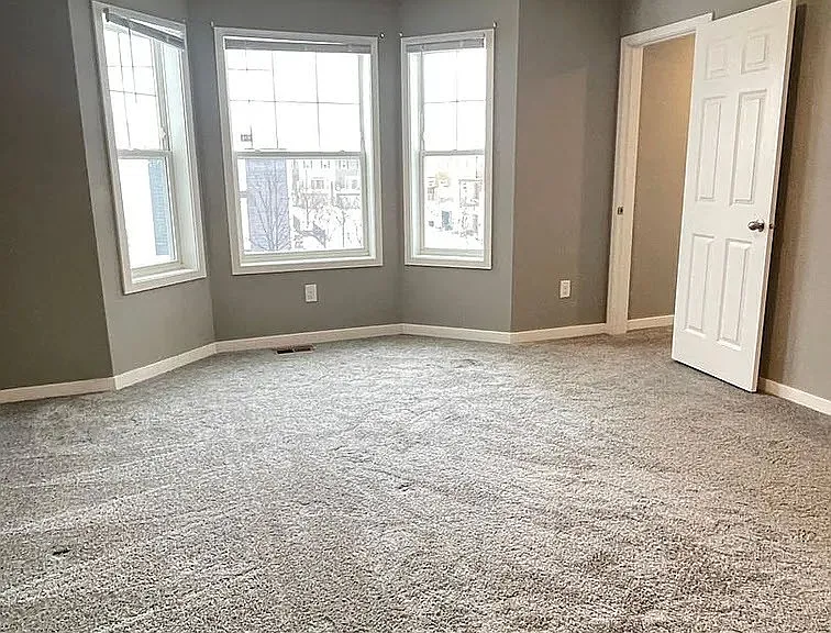 Elegant and spacious, this inviting room at LS Capital Group features abundant natural light, plush carpeting, and modern design. Perfect for creating your ideal living space. Schedule a tour today and envision your new home.