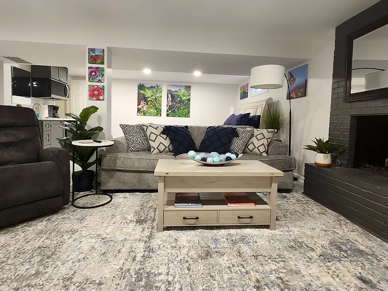 Large comfortable sofa and rocking lounge chair and a wall mounted television