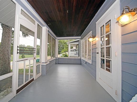 Screened front porch looks out onto Larson Park and Algonquin Golf Course