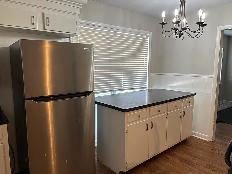 stainless steel refrigerator. Kitchen island shown moved to dinette space