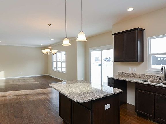 Open space, perfect for gathering, looks out to wooded pond area.