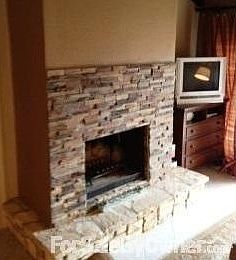Fireplace : Fireplace in living area sorrounded by rock
