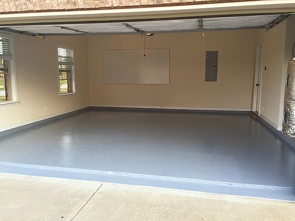 Garage : Freshly coated garage floor; insulated door