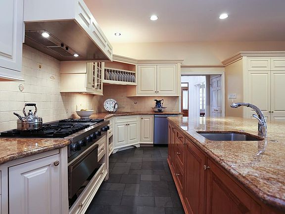 Well planned chef's kitchen with wonderful storage and pull out drawers. Granite island on custom ma