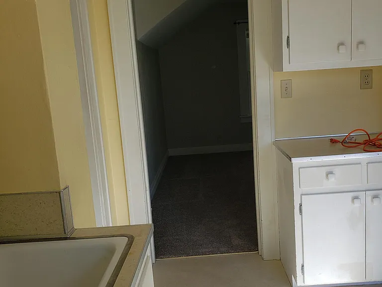 entrance through kitchen to bedroom/living space.