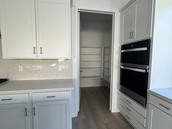 New appliances and white kitchen upgraded quartz countertops with walk-in pantry