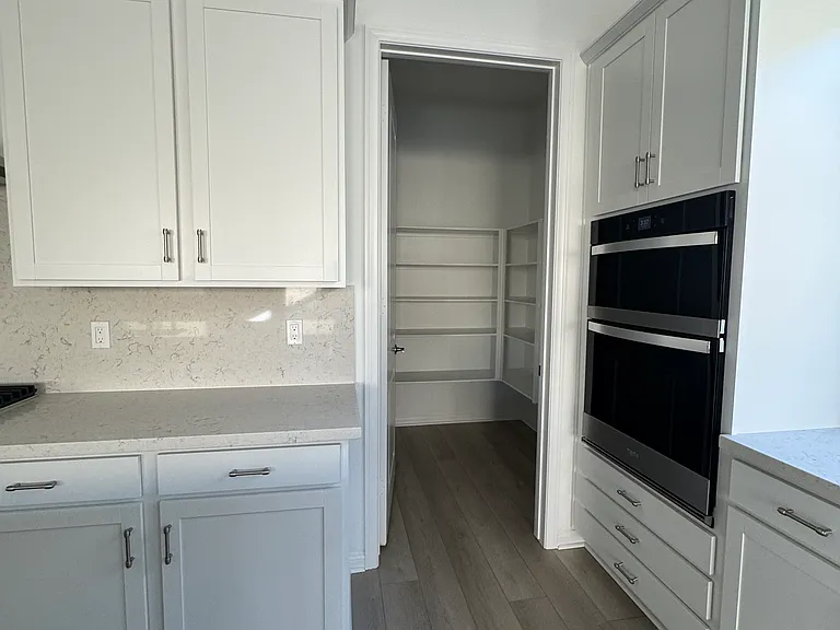 New appliances and white kitchen upgraded quartz countertops with walk-in pantry