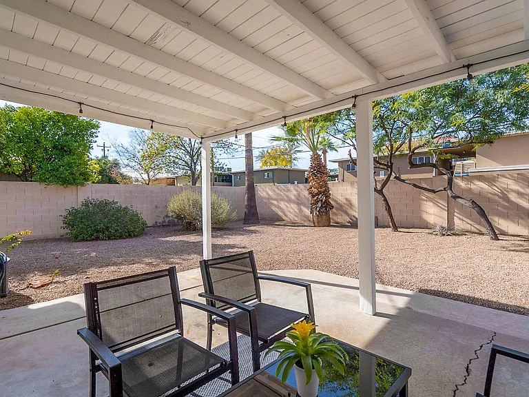 Large, Clean Yard with Covered Patio Seating and Accent Lighting