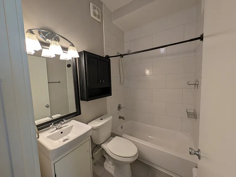 Full bathroom on second floor between bedrooms.