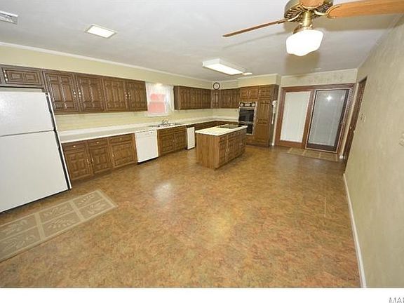 Large Kitchen with island and electric cook top.