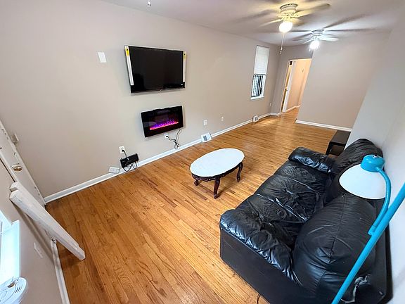 Living Room Includes Mounted TV and Fireplace