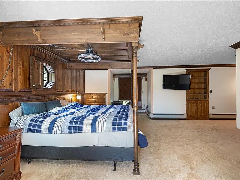Master bedroom with canopy bed - old photo, carpet replaced with new wood floors, example to show room with bed