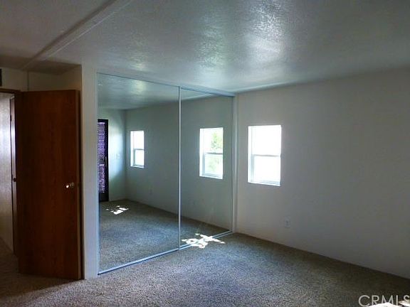 master bedroom with mirrored wardrobe doors and new carpet