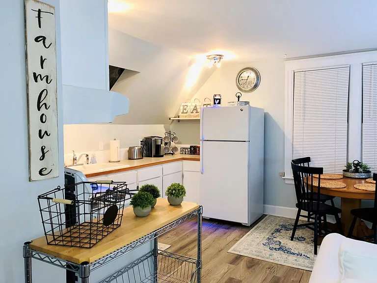 Apartment kitchen, dining & seating area.