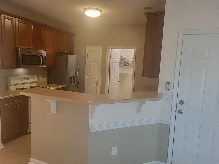 kitchen and laundry room, washer and dryer.
