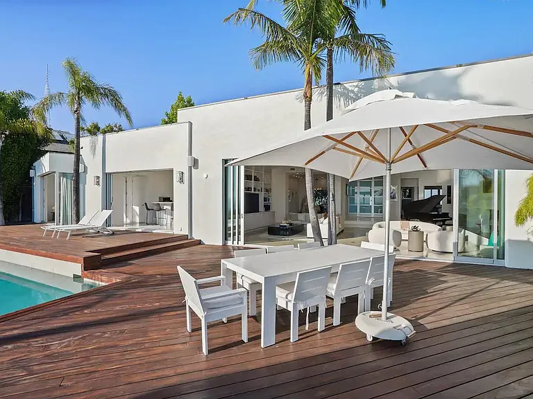 Enjoy the open-air experience with an umbrella-shaded table that seats eight, perfect for memorable gatherings.