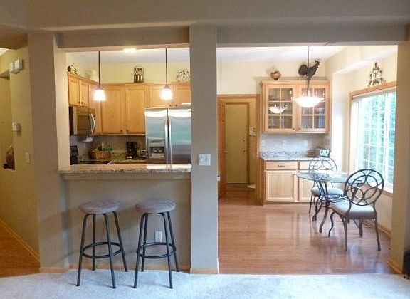 Kitchen open to living area with space for dining room table