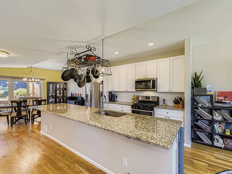Kitchen with huge eat-in island, gas range, and microwave