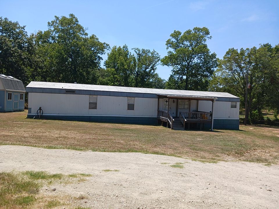front of home with covered front porch andwih storage building on left