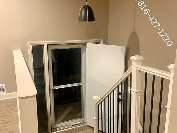 beautiful entry with custom handrail, new lighting and knee wall.