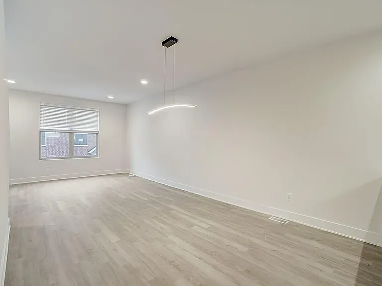 great room with architectural light for over a dining or work table, luxury plank flooring large window with 2" blinds
