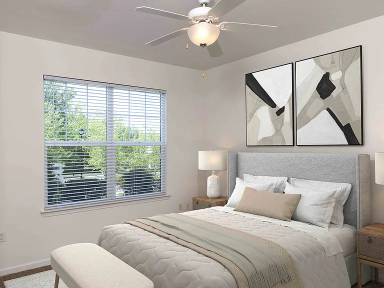 Bedroom with large window and ceiling fan