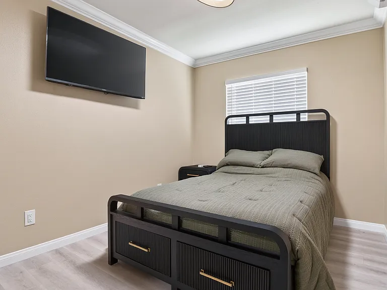 Bedroom with wall-mounted TV
