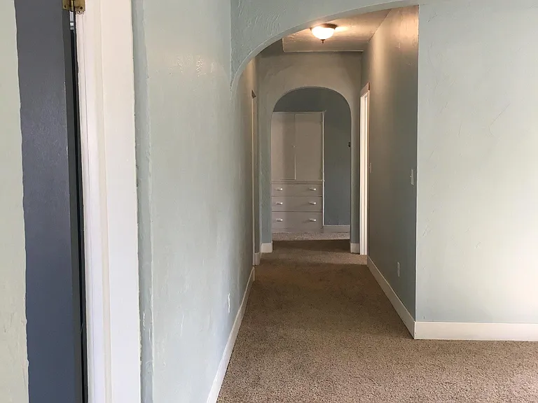 Hallway to kitchen and bathroom and two other bathrooms