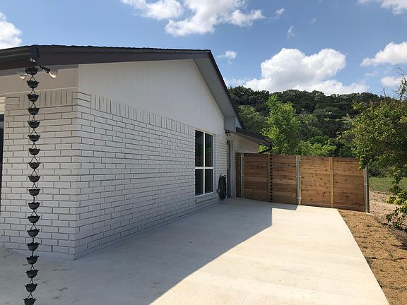 Spacious side patio with privacy wall.