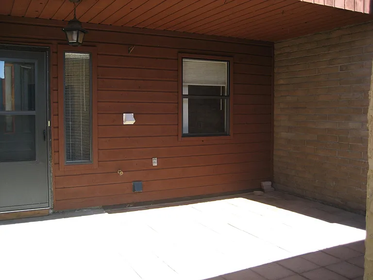 Covered front porch area behind garage.