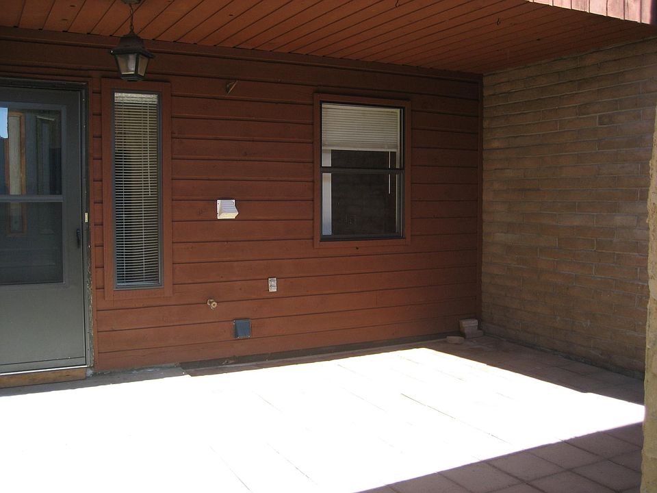 Covered front porch area behind garage.
