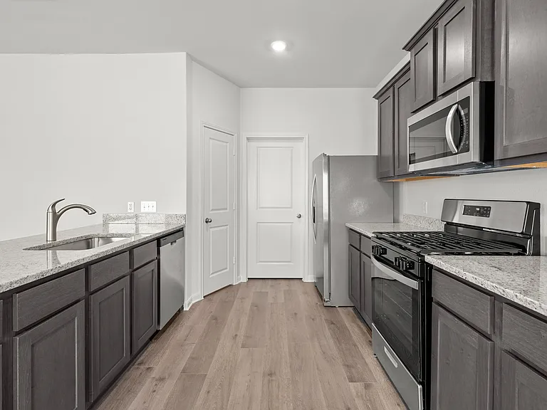 The kitchen has designer wood cabinetry.