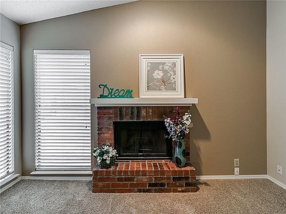 Living room has fireplace and lots of light.