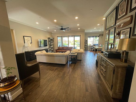 great room with breakfast room in the distance and slider glass doors to California Room and back yard