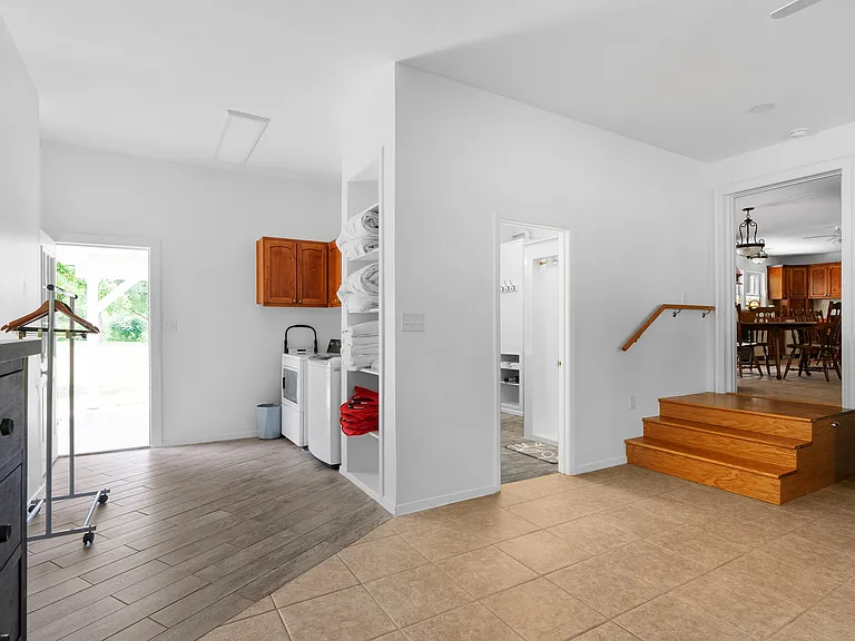 Stairs from dining room to bonus room showing washer dryer