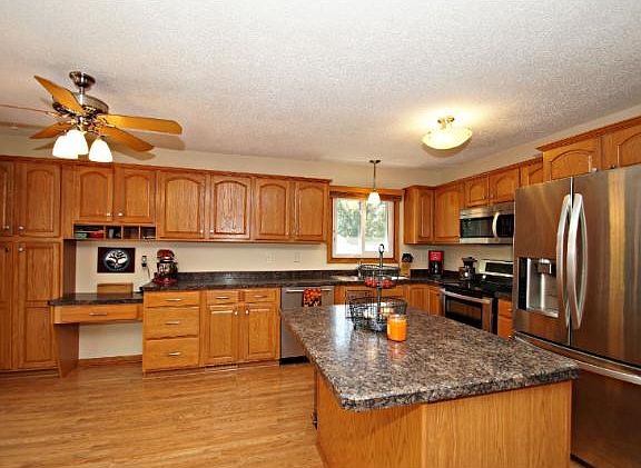 Kitchen has wonderful natural woodwork, lots of cabinet space, ss/appliances, built in little office nook, center island is a great place to enjoy your morning coffee or the kids can sit and get some homework done.