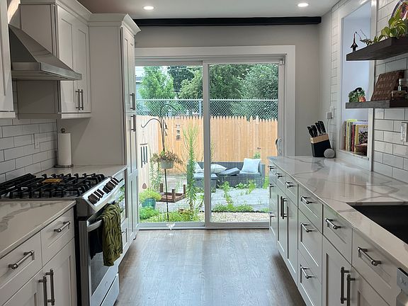Renovated kitchen with sliding doors to fenced in private backyard