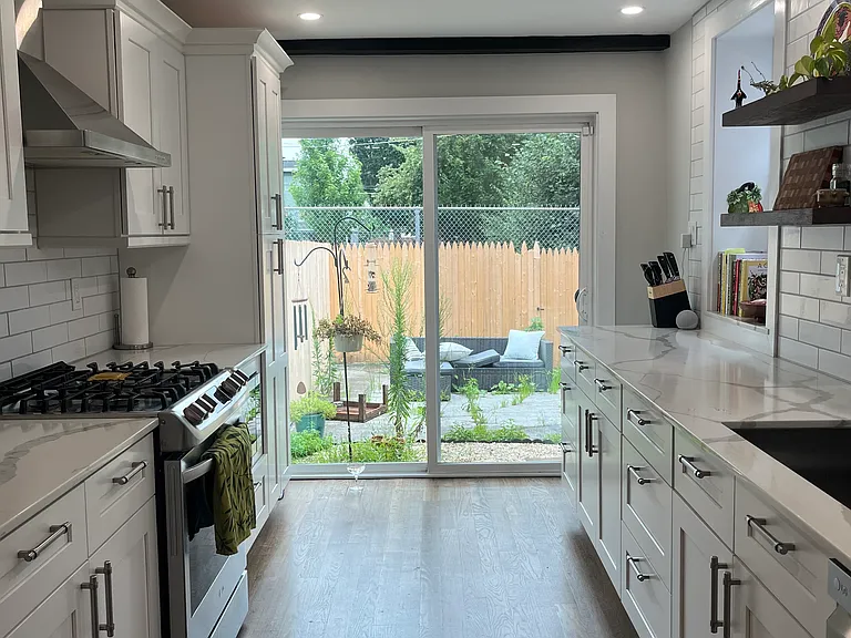 Renovated kitchen with sliding doors to fenced in private backyard