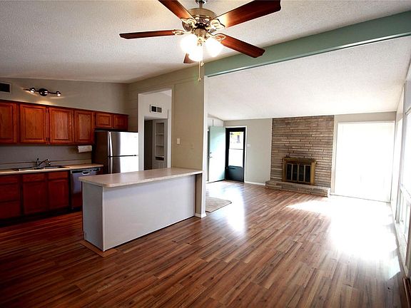 Vaulted ceiling and open floor plan.   Beautiful new flooring and new light fixtures, NEW stainless appliances.  Wood burning fireplace in living room. Lots of windows makes it light and bright.