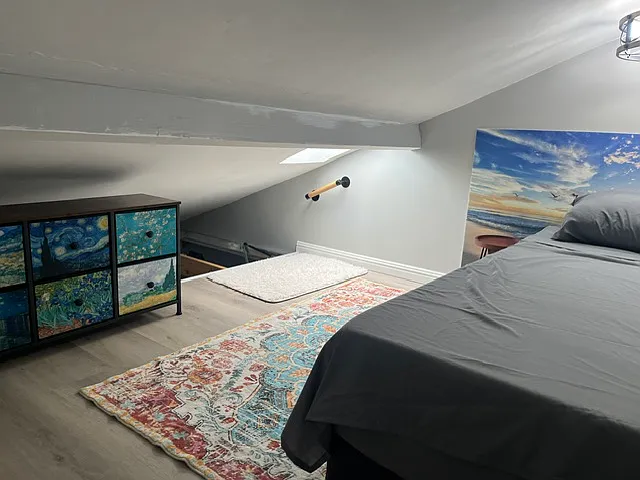 Skylight in loft. Dresser and basket for clothes or blankets etc. Also, the beam has been fully painted grey.