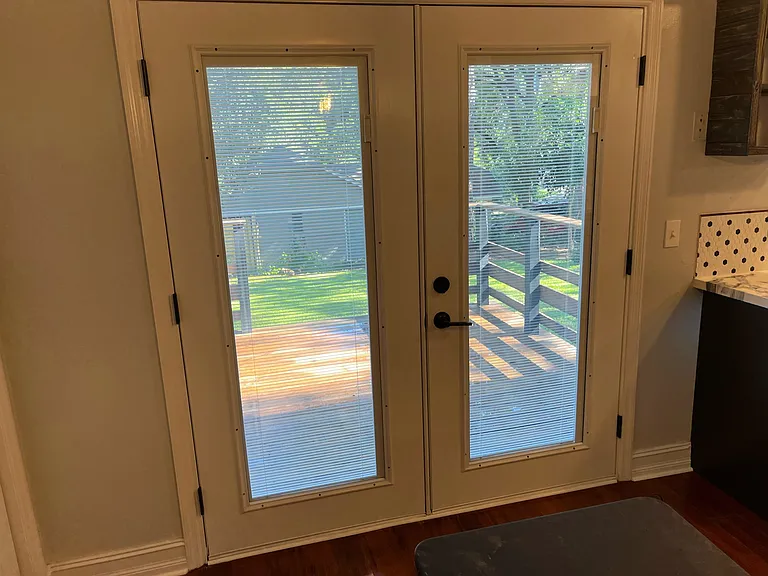 French doors with interior blinds.