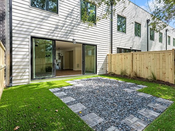 Private fenced in back yard with artificial turf.