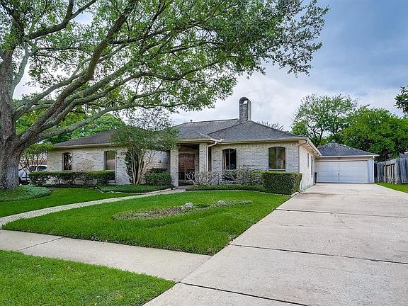 A road view of the home. Long, broad driveway. Neat as a pin. Flower beds are sprinklered, front and rear.