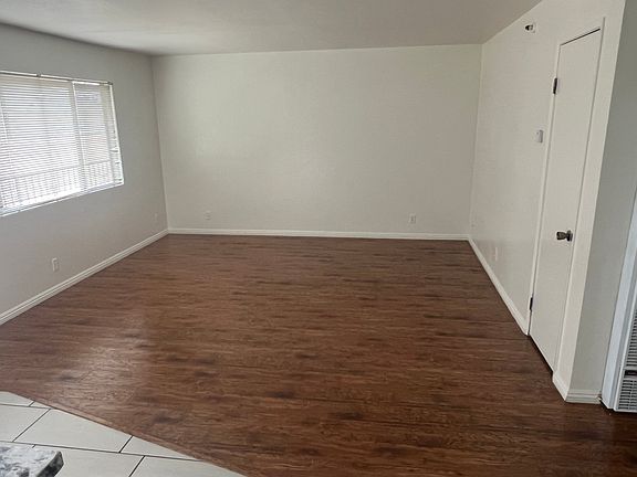 Large living area with freshly polished hardwood floors.