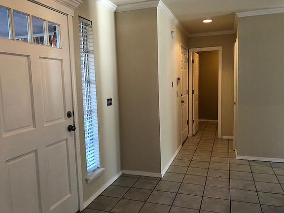 Entry way with coat closet, half bath and garage access.