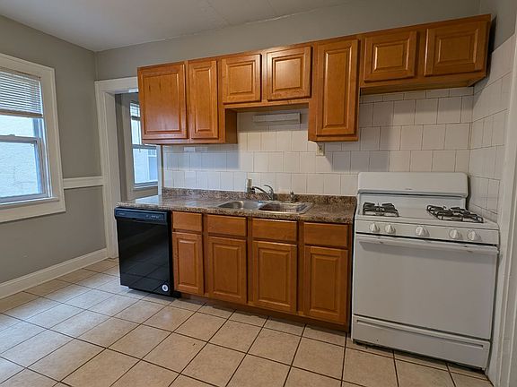 Appliances included are gas stove, fridge, and dishwasher