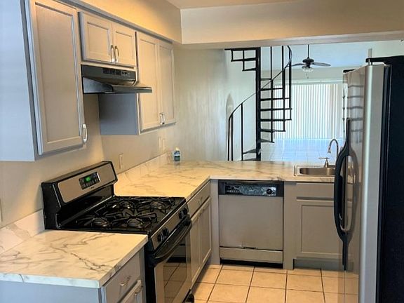 KITCHEN WITH A PASS THROUGH WINDOW.