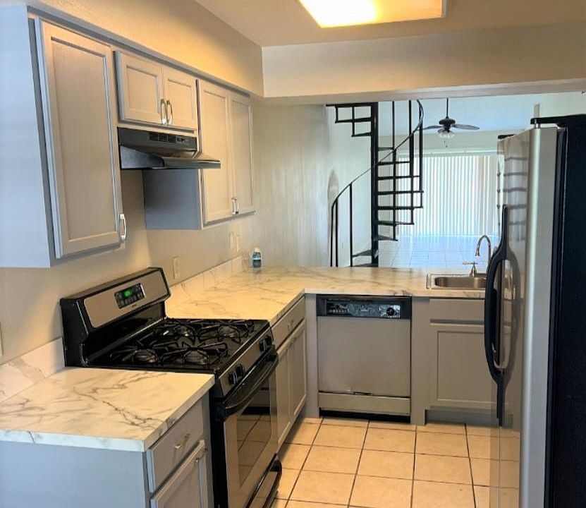 KITCHEN WITH A PASS THROUGH WINDOW.